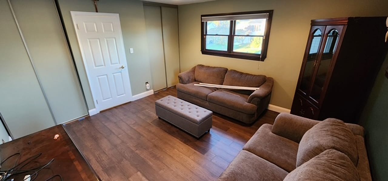 Dark rustic plank flooring installed in a family den by Frankie D’s Flooring