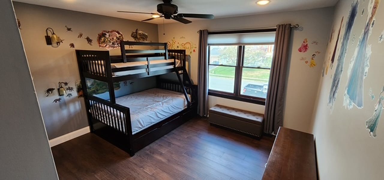 Rustic plank flooring installed in a kids’ bunk-bed room by Frankie D’s Flooring